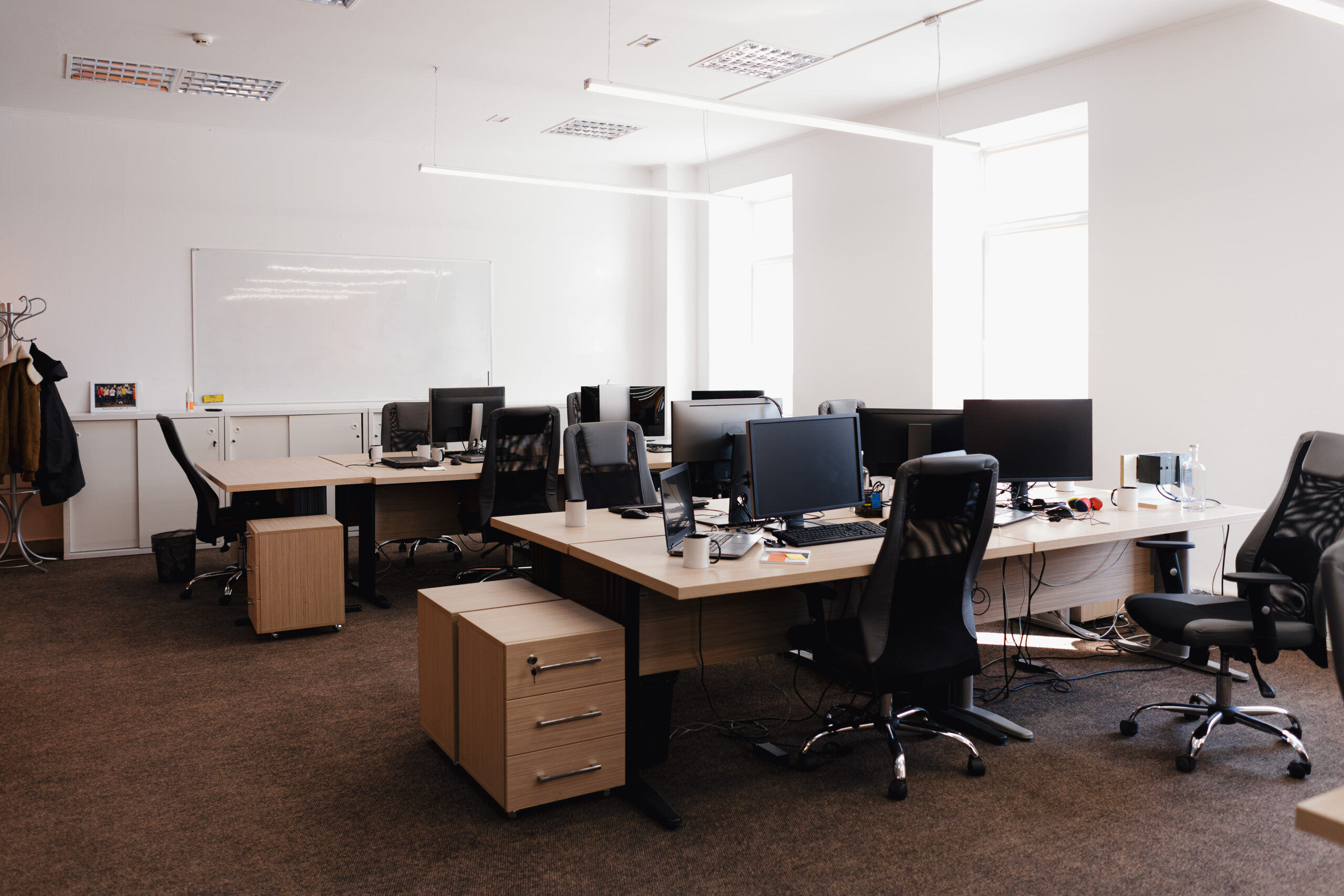 Modern Office Space Interior. IT open space office. Computer Work Stations. Office Workplace with windows.